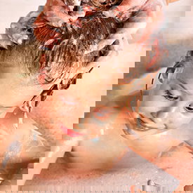 girl getting her hair washed for lice treatment