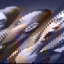 Man telling secret to woman about lice infestation